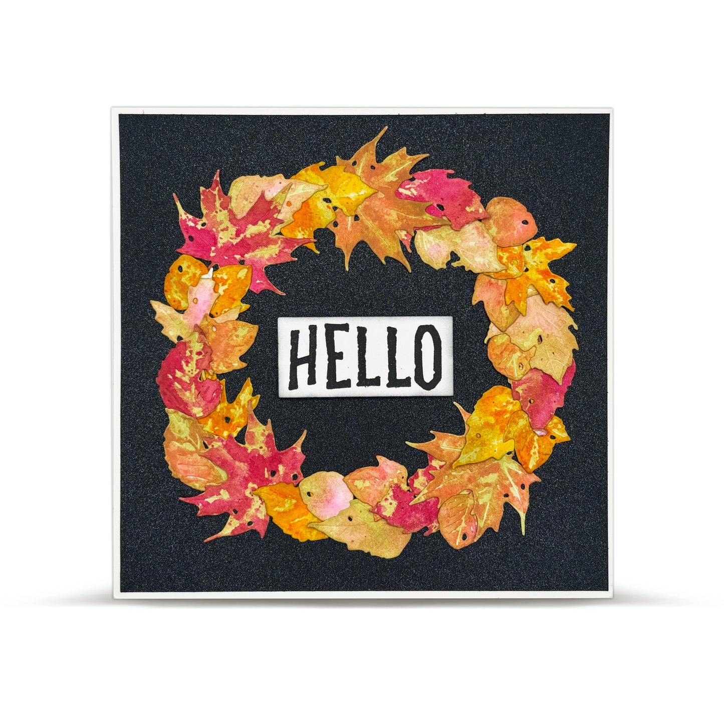 Decorative card with autumn leaf wreath and 'HELLO' text on a black background using the AALL & Create Spelling Spectacle Stamp Set