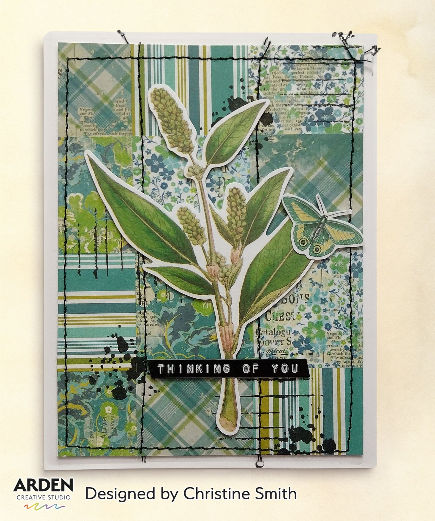 "Thinking of You" card sample using Arden Creative Studio Hidden Creek collection, featuring a large botanical stem die-cut focal point, teal plaid and floral patterned paper background, and black ink splatter detailing.