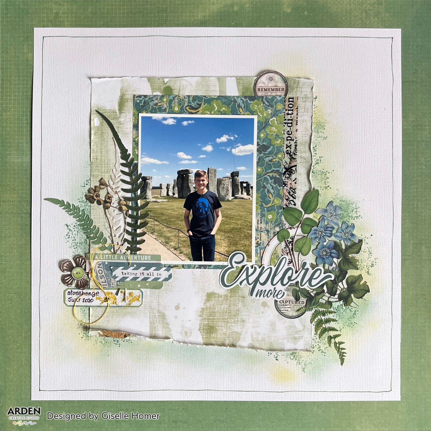 "Explore More" travel scrapbook layout sample using Arden Creative Studio Hidden Creek collection, featuring a Stonehenge holiday photo, botanical fern and floral die-cuts, vintage ticket ephemera, and a teal Moroccan stencilled background.