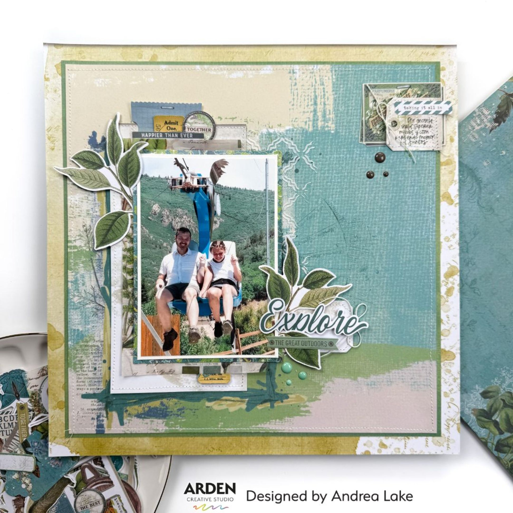 "Explore the Great Outdoors" scrapbook layout sample using Arden Creative Studio Hidden Creek collection, featuring a holiday photo, large botanical leaf die-cuts, teal linen-texture patterned paper, and mixed media brush stroke background in teal, sage and cream.