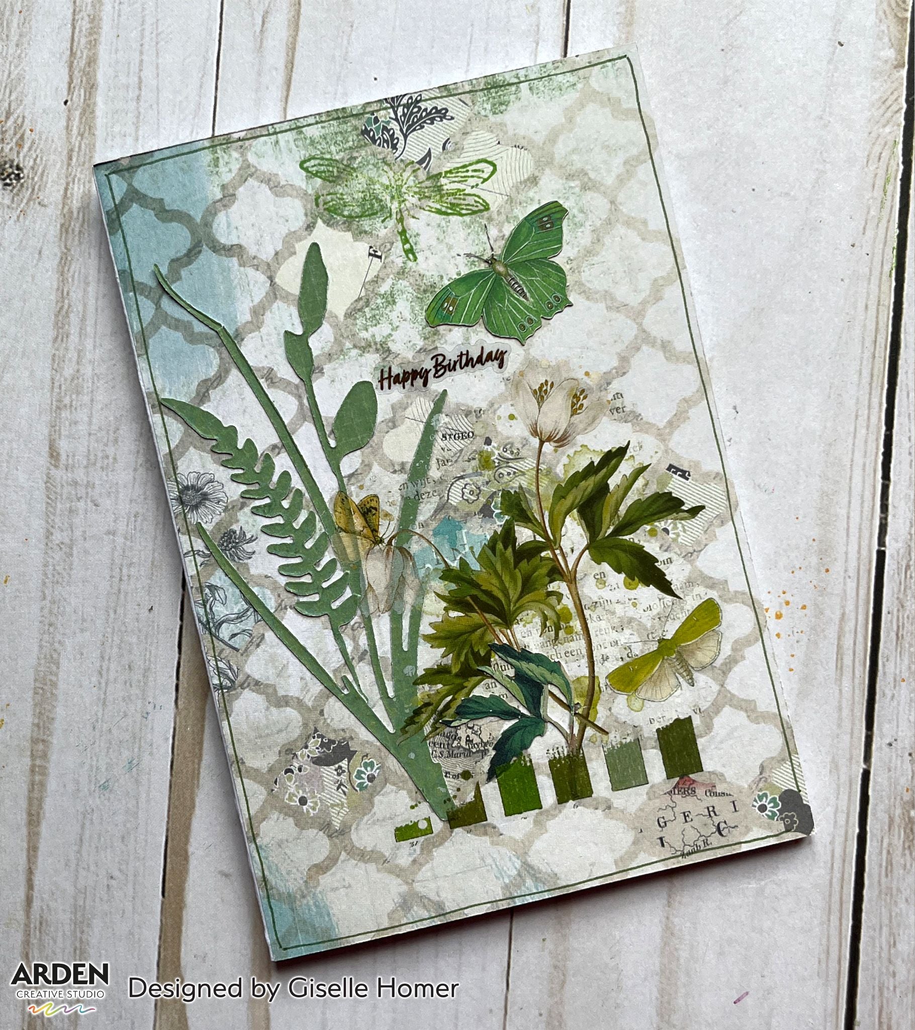 "Happy Birthday" handmade card sample using Arden Creative Studio Hidden Creek collection, featuring botanical fern and floral die-cuts in green, dragonfly and butterfly stamps, and a Moroccan lattice stencilled background in sage and teal tones.