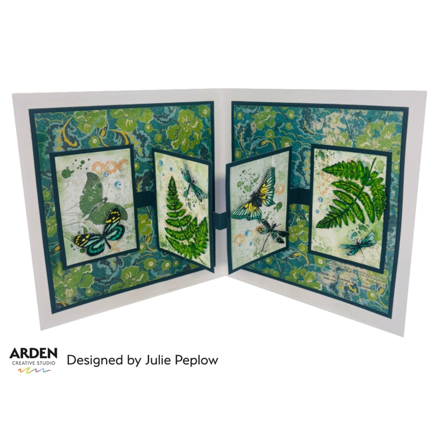 Open gate fold card sample using Arden Creative Studio Hidden Creek collection, featuring butterfly and dragonfly stamping, large fern die-cuts in vibrant green, and a teal botanical floral patterned paper background across four panels.