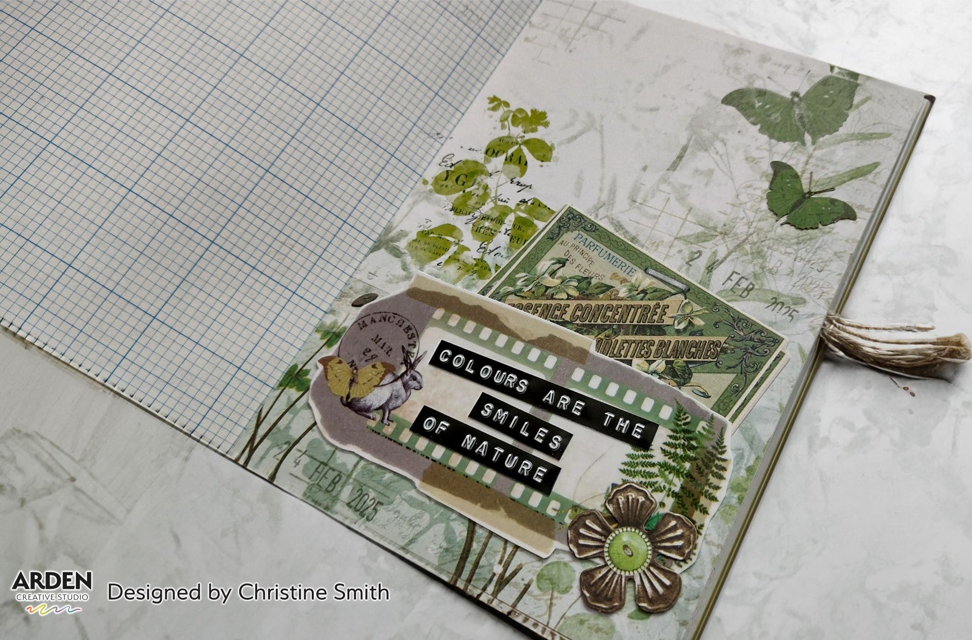 "Colours Are the Smiles of Nature" junk journal page sample using Arden Creative Studio Hidden Creek collection, featuring botanical patterned paper, vintage French ephemera, film strip die-cut, squirrel die-cut, and a bronze flower embellishment on a green grid background.