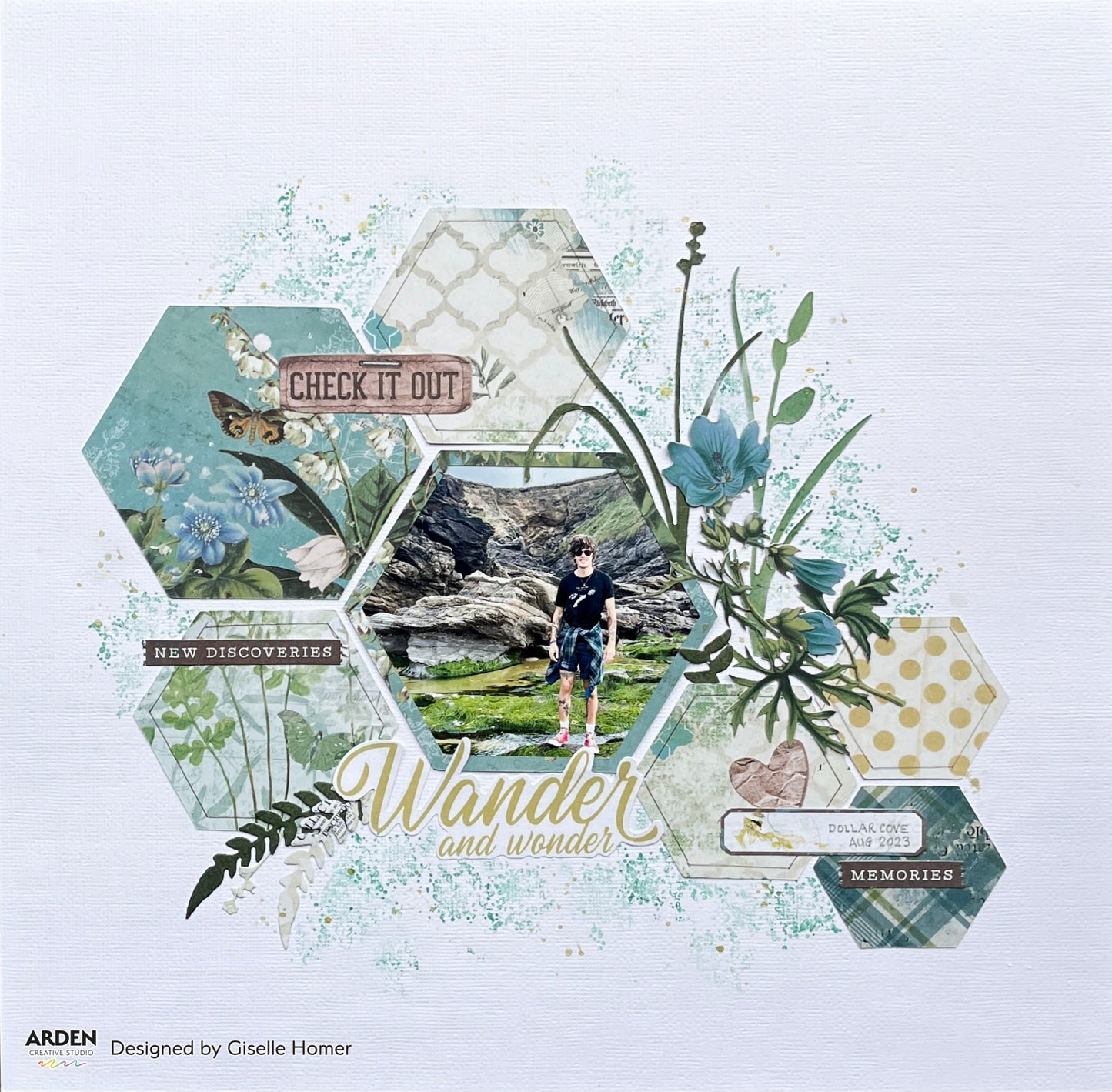 "Wander and Wonder / Check It Out / New Discoveries" scrapbook layout sample using Arden Creative Studio Hidden Creek collection, featuring hexagon die-cut photo mats, teal botanical floral patterned papers, large leaf and fern die-cuts, and a teal mixed media ink splatter background.