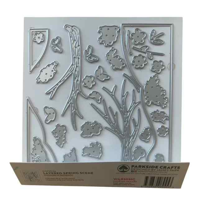Reverse view of the Layered Spring Scene packaging showing the steel cutting dies for trees, branches, flowers, butterflies and other scene elements