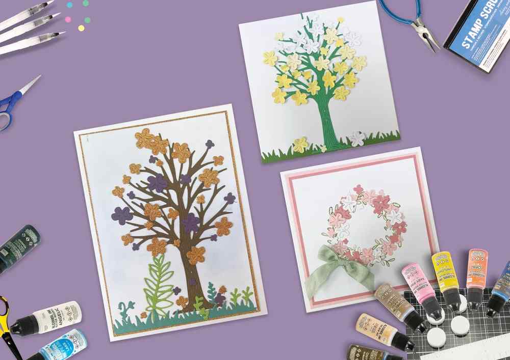 Three handmade floral projects made with the Layered Spring Tree die set, including flowering tree cards and a wreath-style design using blossom and foliage elements