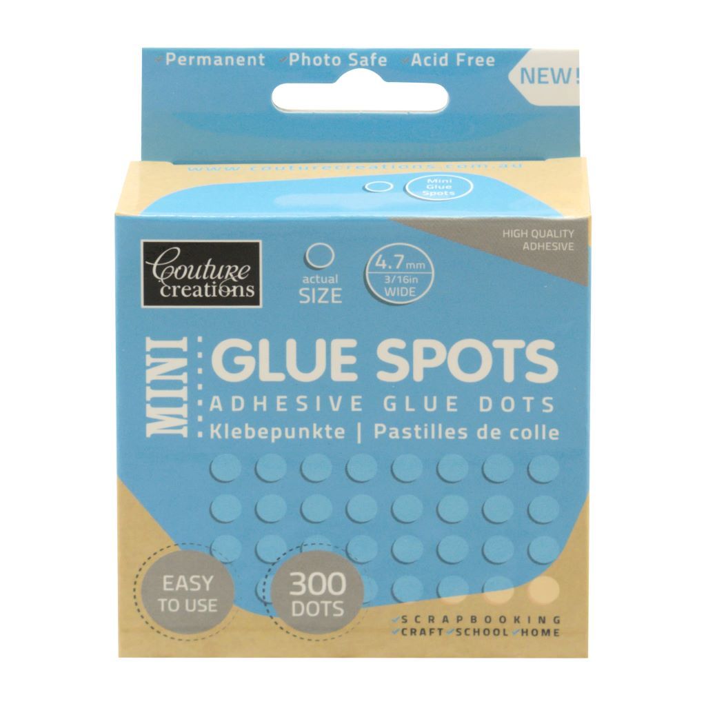 Box of Mini Glue Spots from Couture Creations in blue and beige on a white background. 