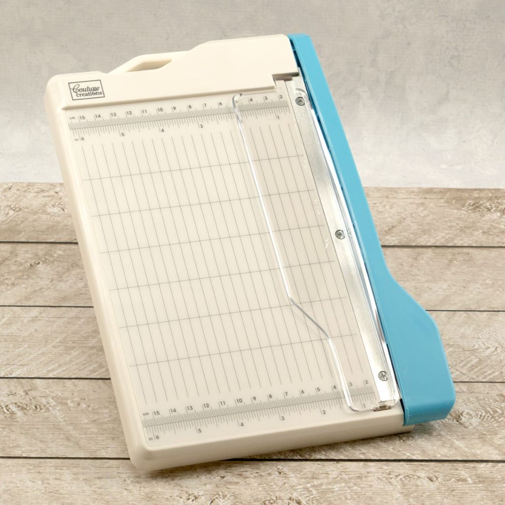 Guillotine paper trimmer with grid on a wooden surface