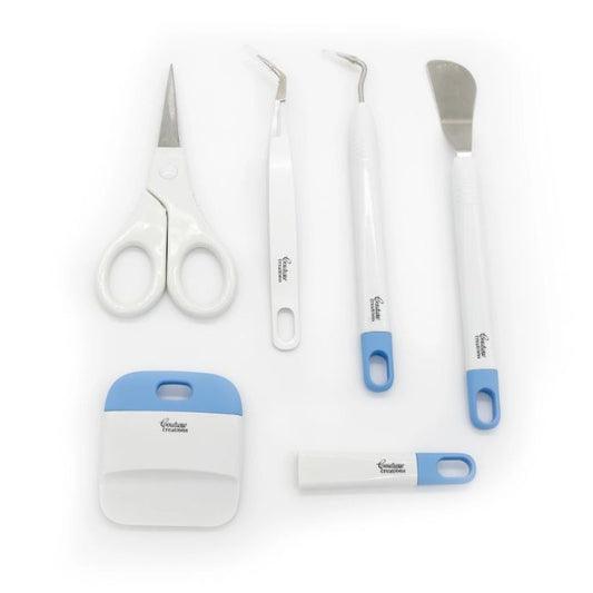 Set of scissors and paper craft tools on a white background