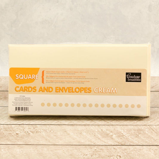 Pack of 50 Square Cards and Envelopes Cream on a wooden surface