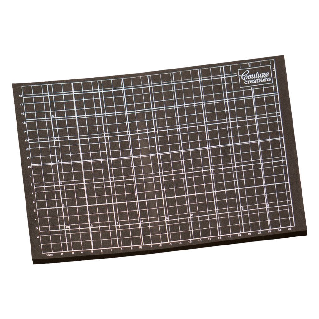 Grid-patterned stamping and pricking mat with 'Couture Creations' branding on a white background