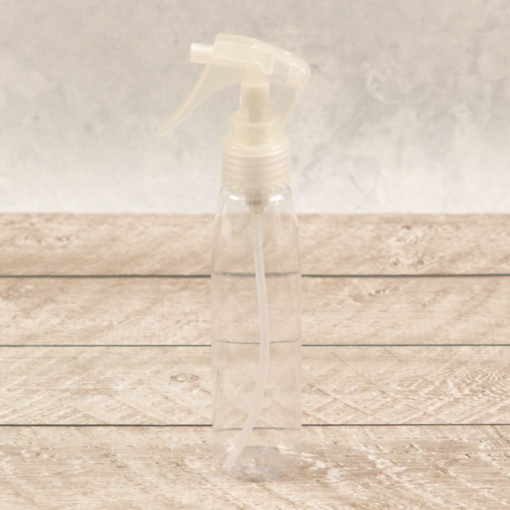 Clear 100ml turbo spray bottle with precision nozzle on wooden background perfect for alcohol inks and mixed media crafts