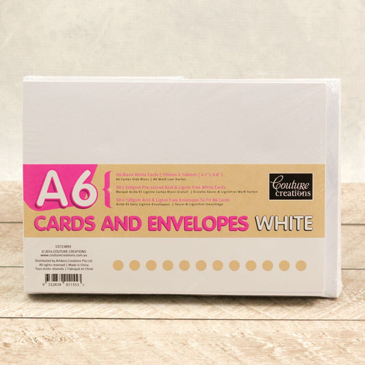 Pack of white A6 cards and envelopes on a wooden surface
