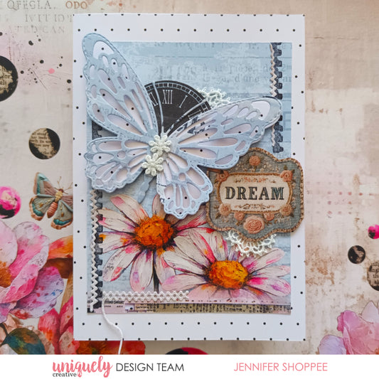 Handmade card featuring Uniquely Creative Dressed in Daydreams blue butterfly die-cut with lace daisies, vintage clock background, watercolour daisies and 'Dream' sentiment