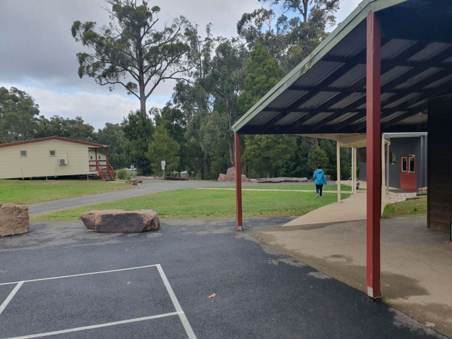 Covered walkway and grounds at Lyrebird Park retreat venue showing peaceful natural surroundings in Victoria