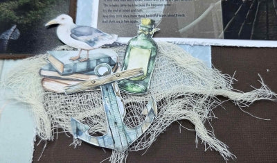 Detail of Beachside Life scrapbook layout with seagull, fishing net, bottle and coastal journaling card