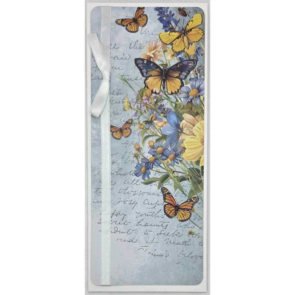 Honey Fields slimline card with white satin ribbon tie, featuring butterfly and wildflower fussy cut embellishments on a soft blue journaling-style background