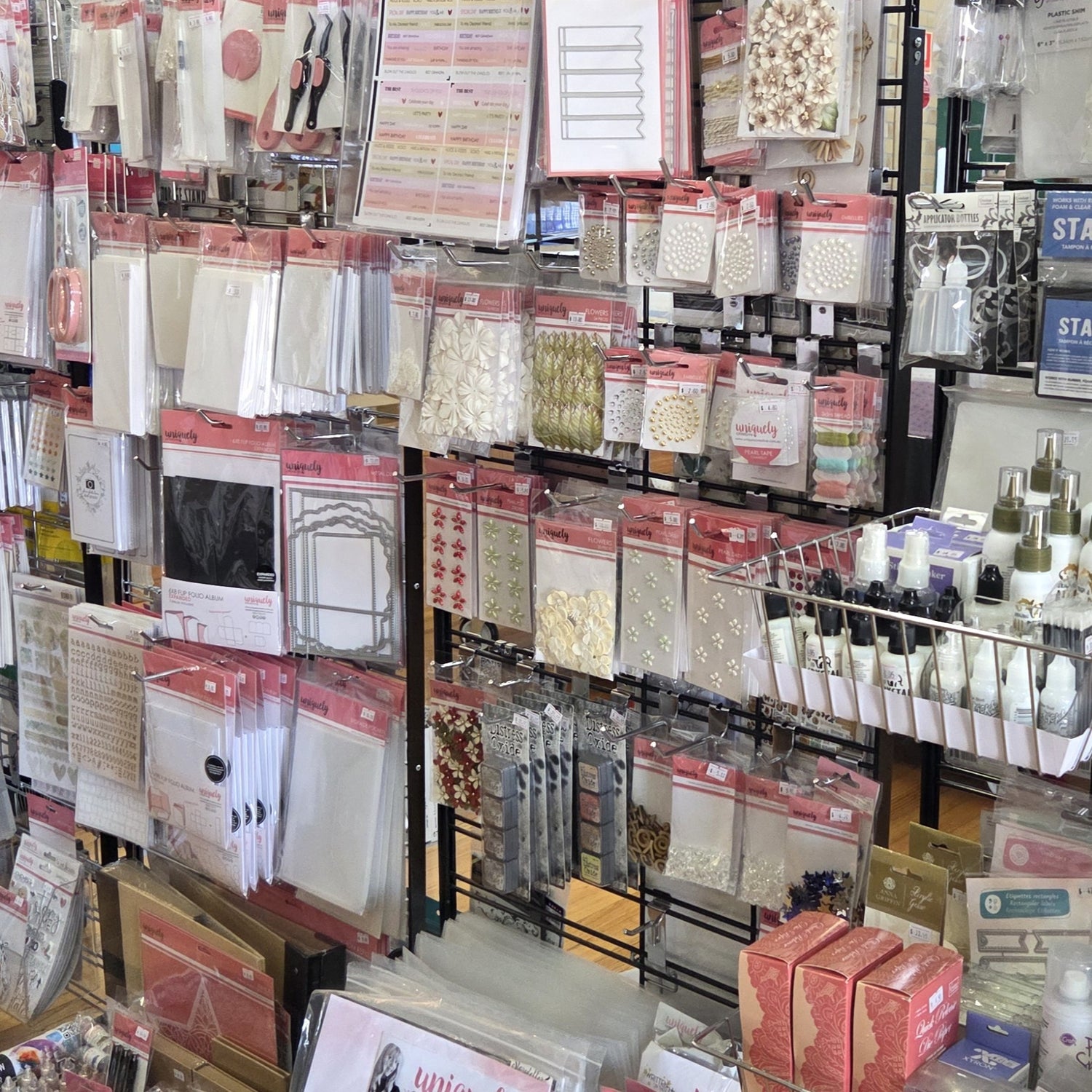 Organised display of papercrafting supplies including embellishments, die-cuts, and decorative elements at Handmade Haven pop-up shop