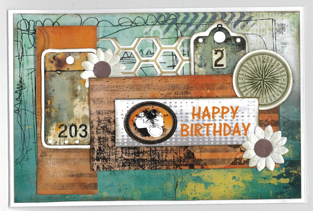 Oh Texture Happy Birthday card with teal and orange textured papers, camera, compass, number tags and white paper flowers