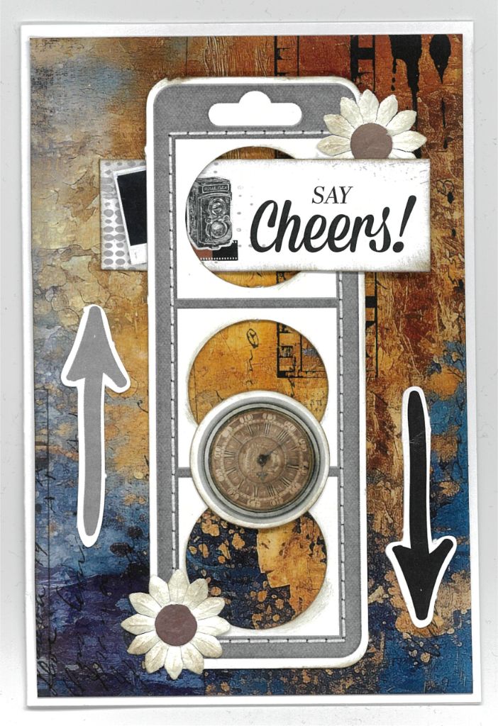 Oh Texture Say Cheers card with camera, clock, arrows and white paper flowers on blue and ochre textured paper