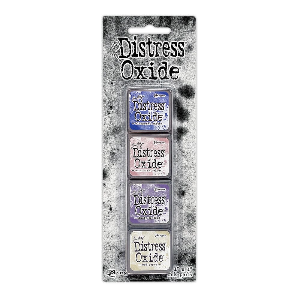 Packaged set of four Ranger Distress Oxide Mini Ink Pads from Kit 11 in Blueprint Sketch, Victorian Velvet, Dusty Concord and Old Paper, shown in original Tim Holtz packaging with grungy black-and-white background.
