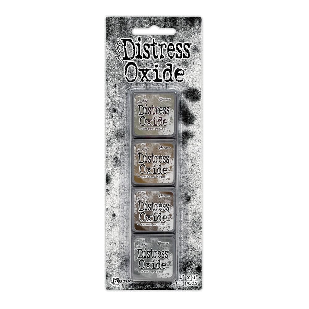 Packaged set of four Ranger Distress Oxide Mini Ink Pads from Kit 12 in Frayed Burlap, Gathered Twigs, Ground Espresso and Hickory Smoke, shown in original Tim Holtz packaging with grungy black-and-white background.
