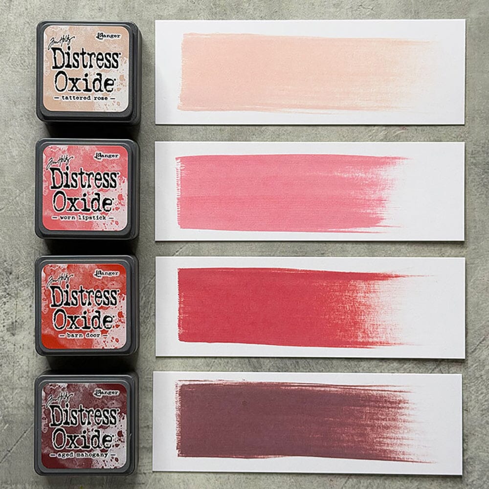 Four Ranger Distress Oxide ink pads from Kit 13 with swatched colours: Tattered Rose, Worn Lipstick, Barn Door and Aged Mahogany, shown on white paper beside each labelled pad.
