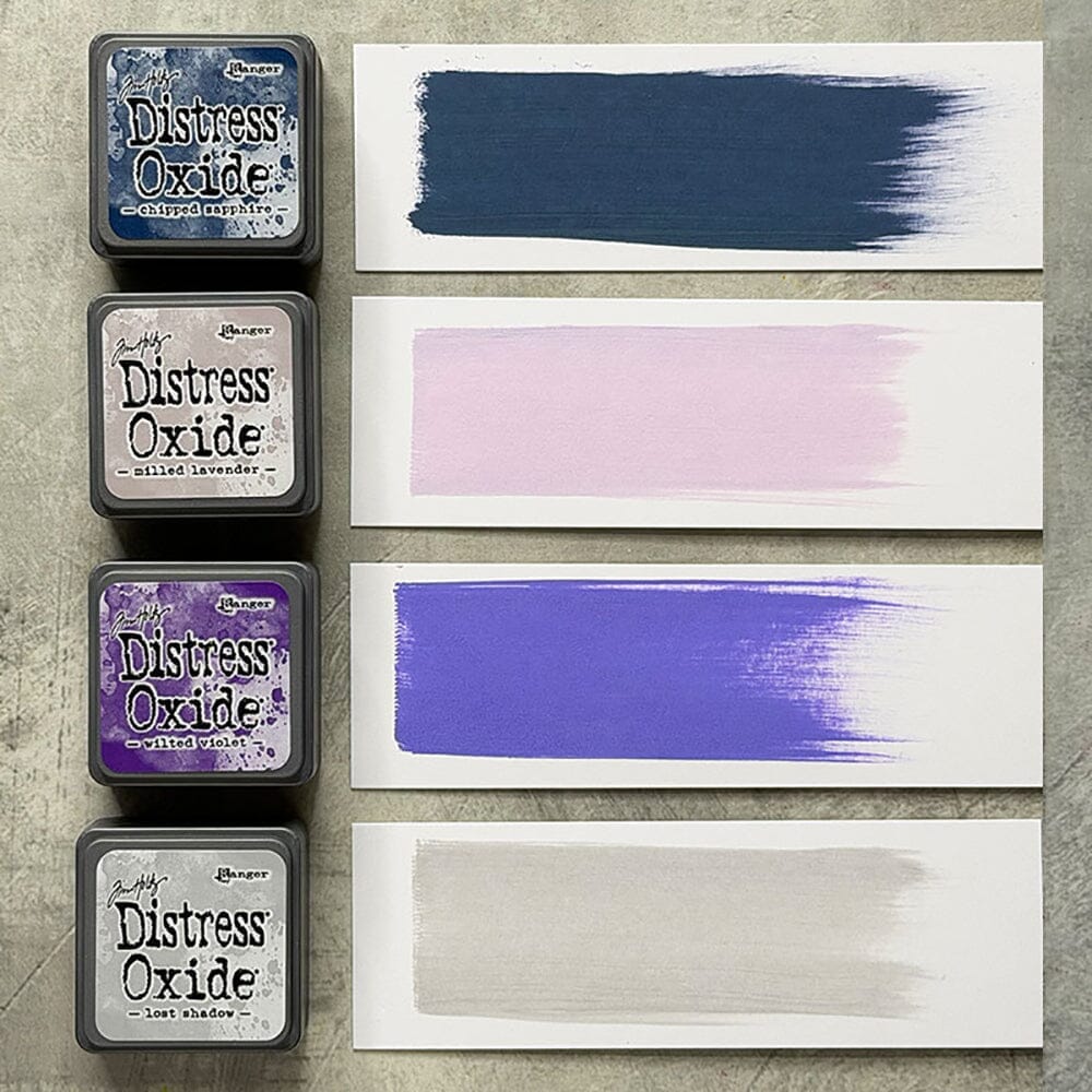 Four Ranger Distress Oxide ink pads from Kit 17 with swatched colours: Chipped Sapphire, Milled Lavender, Wilted Violet and Lost Shadow, shown on white paper beside each labelled pad.
