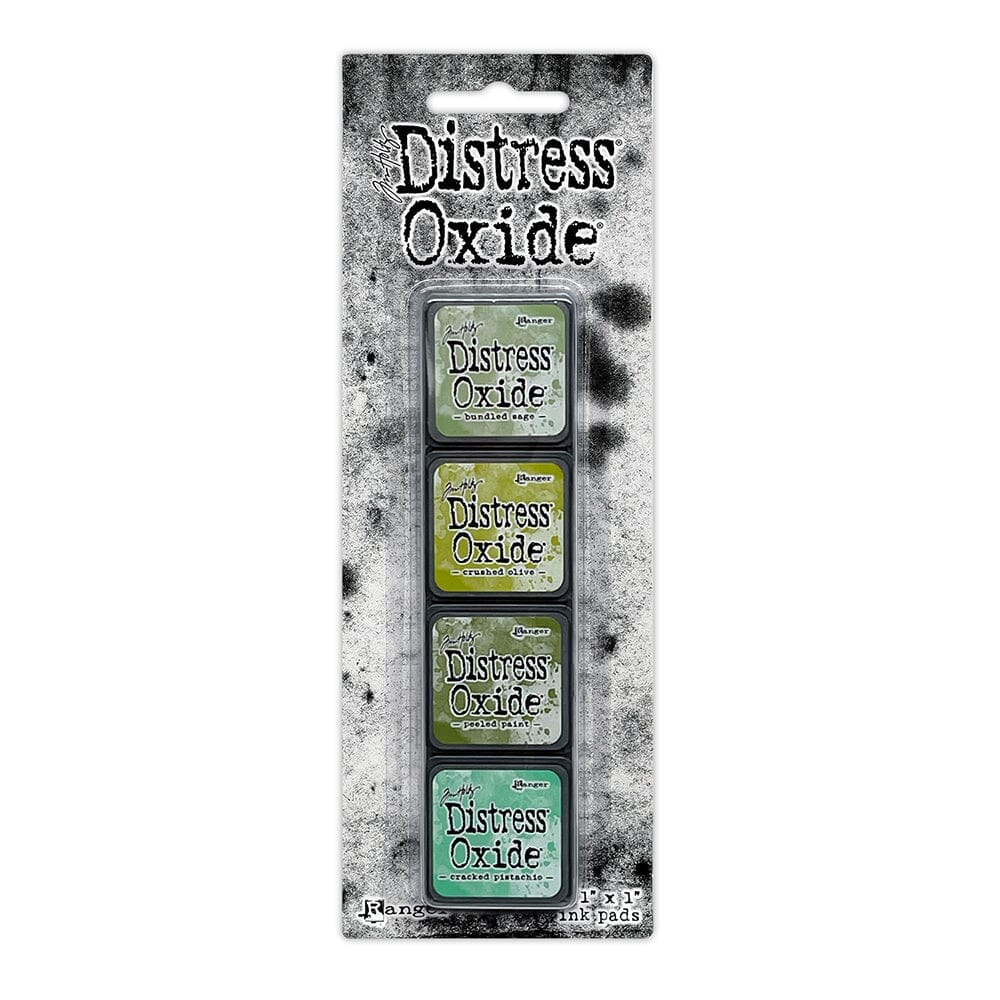 Packaged set of four Ranger Distress Oxide Mini Ink Pads from Kit 3 in Bundled Sage, Crushed Olive, Peeled Paint and Cracked Pistachio, shown in original Tim Holtz packaging with grungy black-and-white background.
