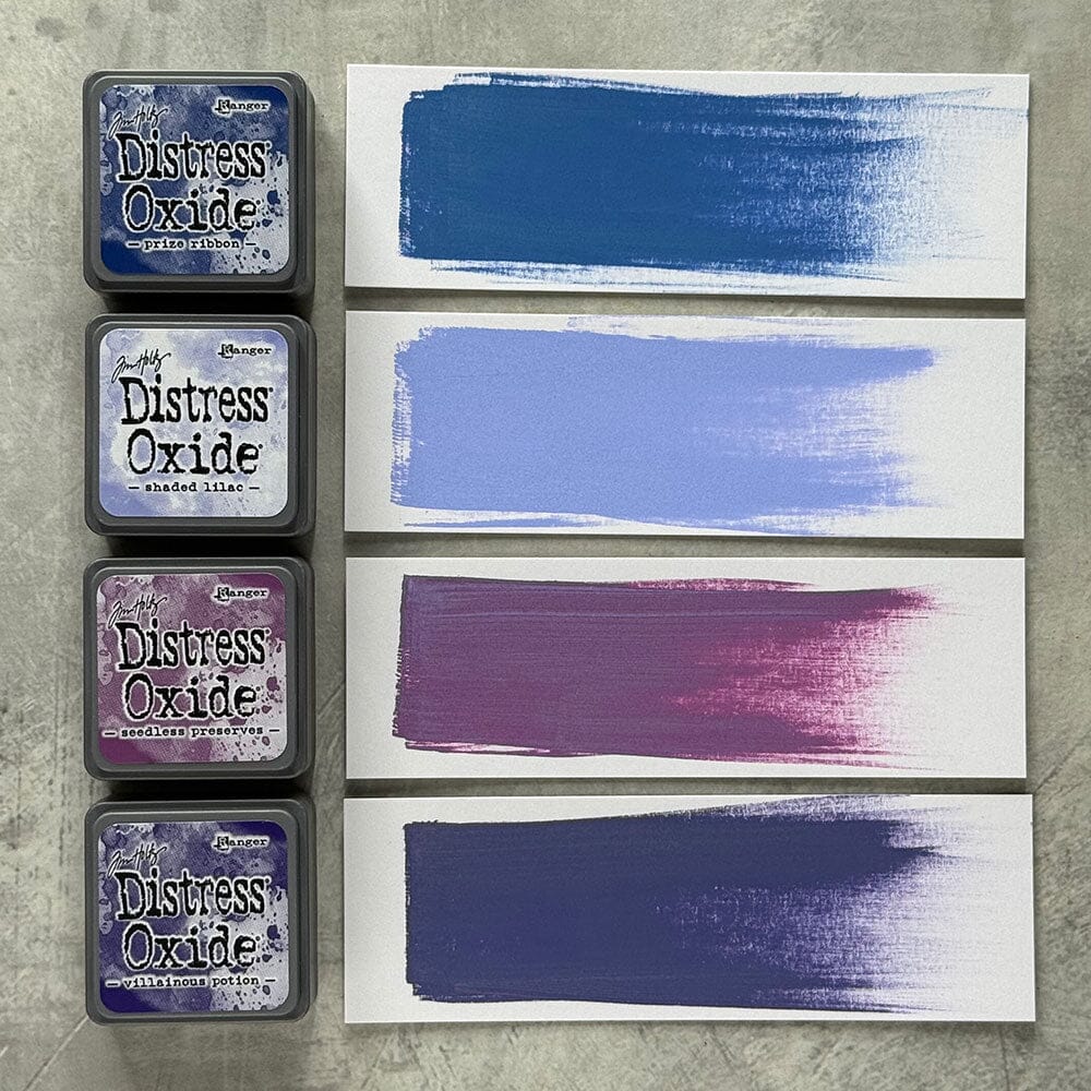 Four Ranger Distress Oxide ink pads from Kit 5 with swatched colours: Prize Ribbon, Shaded Lilac, Seedless Preserves and Villainous Potion, shown on white paper beside each labelled pad.
