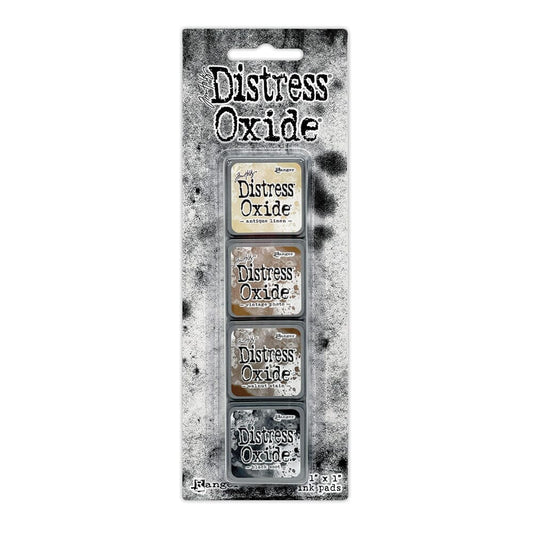 Packaged set of four Ranger Distress Oxide Mini Ink Pads from Kit 6 in Antique Linen, Vintage Photo, Walnut Stain and Black Soot, shown in original Tim Holtz packaging with grungy black-and-white background.
