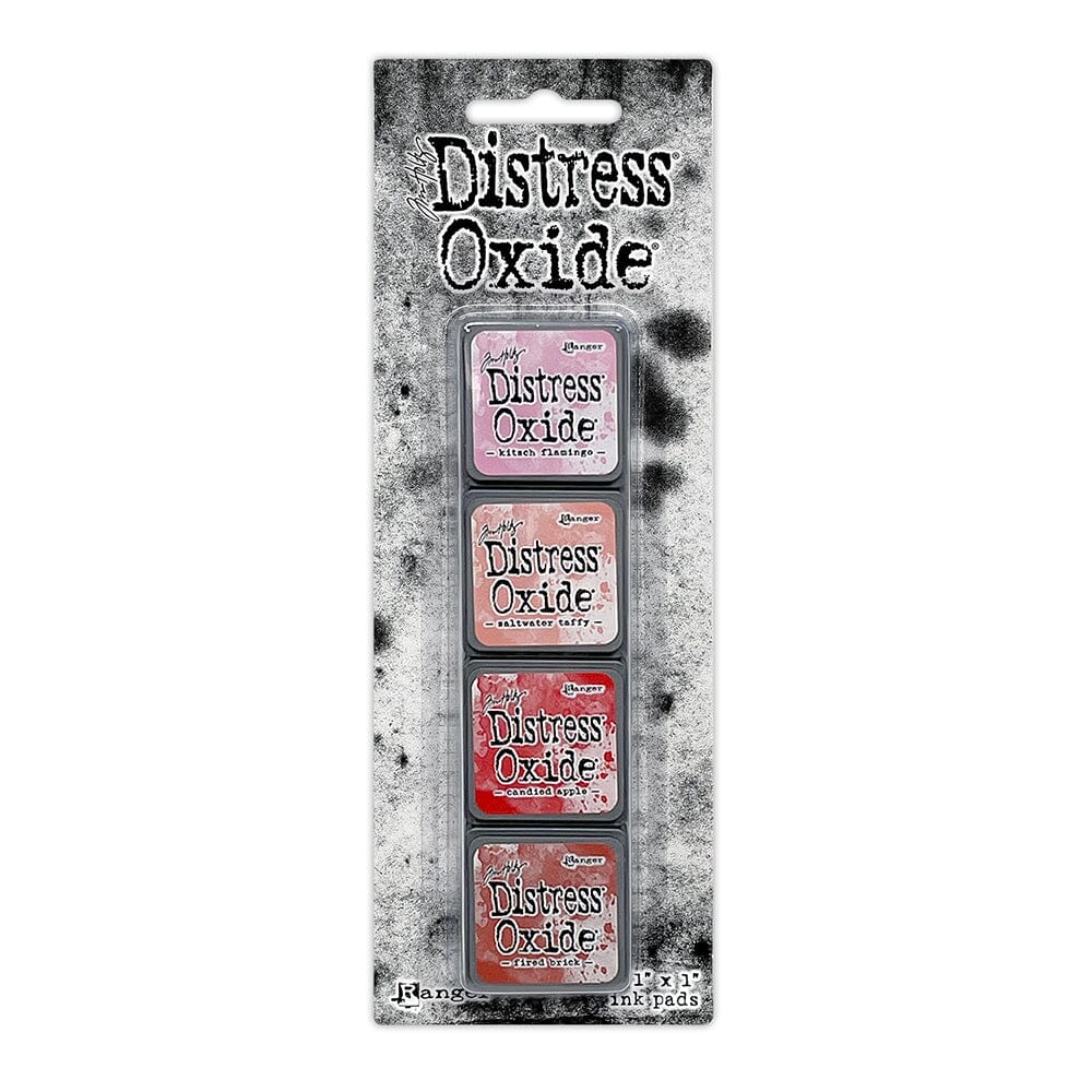 Packaged set of four Ranger Distress Oxide Mini Ink Pads from Kit 7 in from Kitsch Flamingo, Saltwater Taffy, Candied Apple and Fired Brick, shown in original Tim Holtz packaging with grungy black-and-white background.
