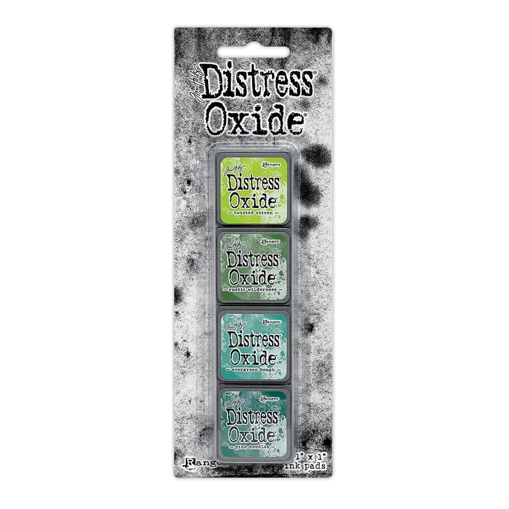 Packaged set of four Ranger Distress Oxide Mini Ink Pads from Kit 9 in Twisted Citron, Rustic Wilderness, Evergreen Bough and Pine Needles, shown in original Tim Holtz packaging with grungy black-and-white background.
