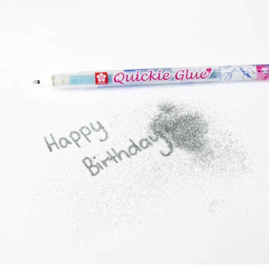 Sakura Quickie Glue Pen applied to paper with glitter showing precise adhesive control for card making