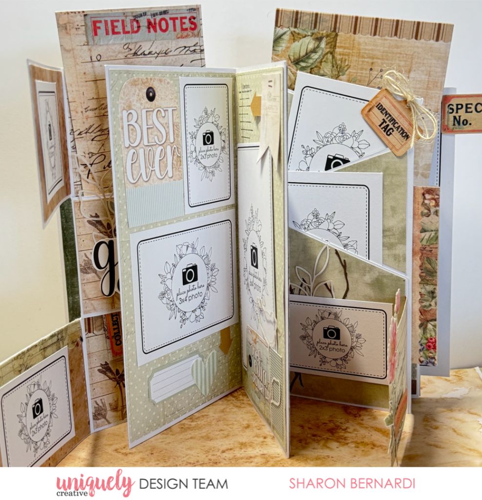 Handmade “Everything Folio” by Sharon Bernardi using Uniquely Creative Botanical Chronicles collection – features fold-out pages, photo place holders, and pockets adorned with vintage-style papers, botanical tags, and embellishments like hearts, leaves, and labels. A beautifully layered design for creative memory keeping and photo journalling.
