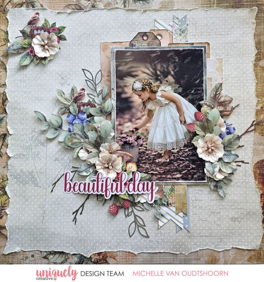 Scrapbook page by Michelle Van Oudtshoorn using Uniquely Creative Botanical Chronicles collection – features a nature photo of a girl in a white dress picking flowers, framed by lush embellishments like birds, berries, and layered florals. Neutral textured background and “beautiful day” sentiment evoke a peaceful, woodland-inspired memory.