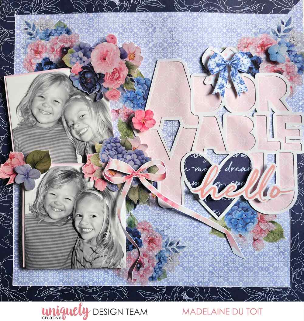 Pink and blue floral scrapbook layout with two black-and-white photos and a pink paper-backed Adorable You overlay