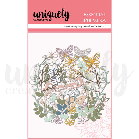 A package of "Essential Ephemera" by Uniquely Creative, featuring die-cut paper embellishments like butterflies, flowers, and leaves in pastel and earthy tones, designed for scrapbooking and card making.