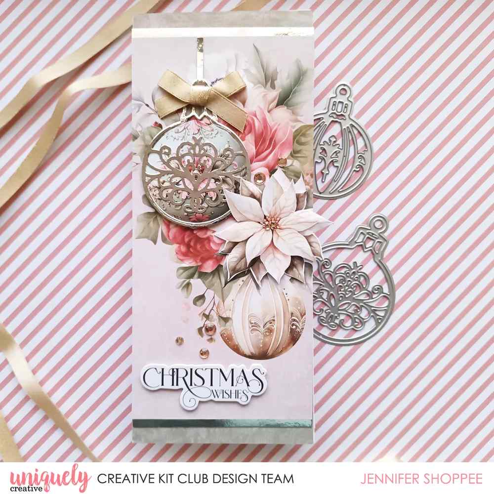 Christmas card featuring silver filigree bauble die cuts with pink roses, a poinsettia and a Christmas Wishes sentiment