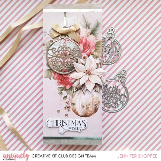 Christmas card featuring silver filigree bauble die cuts with pink roses, a poinsettia and a Christmas Wishes sentiment