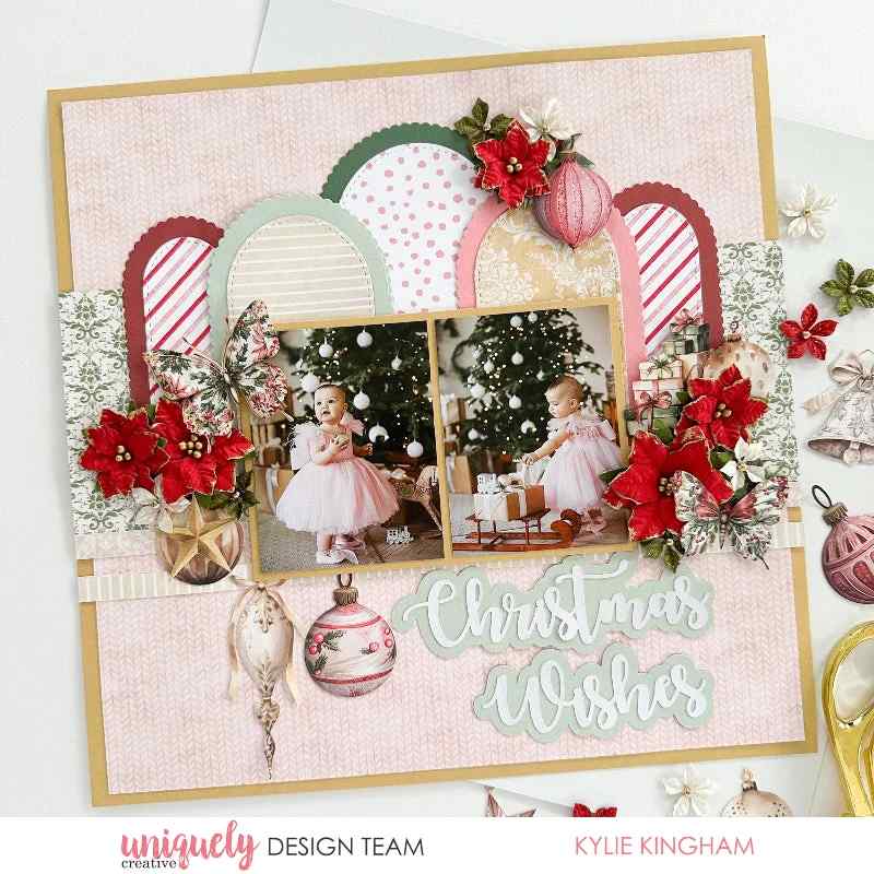 Christmas scrapbook page decorated with red and gold poinsettia flower embellishments and coordinating festive paper elements 