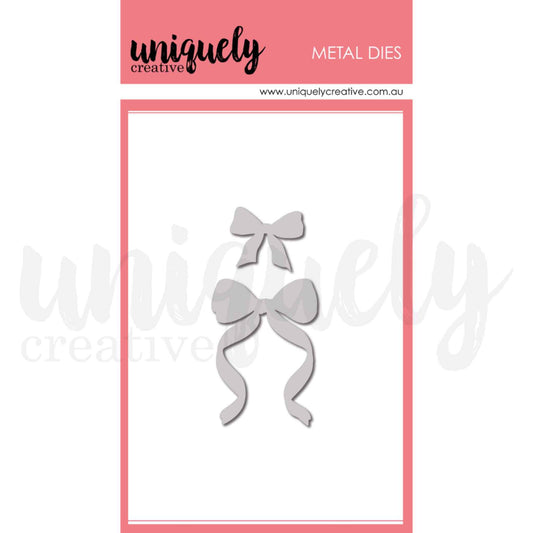 Uniquely Creative Classic Bows Die set showing two metal dies — a small neat bow approximately 1 by 1 inch and a larger bow with long flowing ribbon tails approximately 1 and three quarter by 2 and a quarter inches