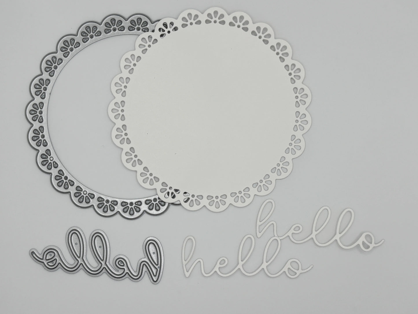 White die-cut doily frames and script hello sentiments in outline and solid versions showing the Uniquely Creative Delicate Doily Die cutting results