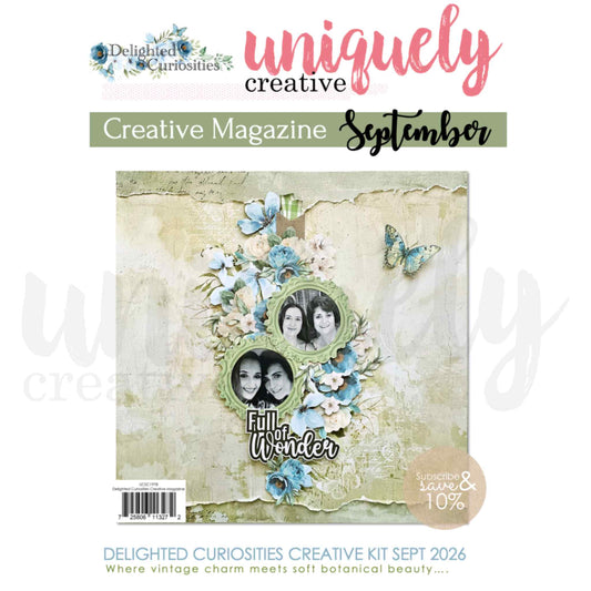 Uniquely Creative Delighted Curiosities Creative Magazine September 2026, cover showing a scrapbook layout with circular photo frames, blue florals, butterflies, and the Full of Wonder title on a distressed plaster background