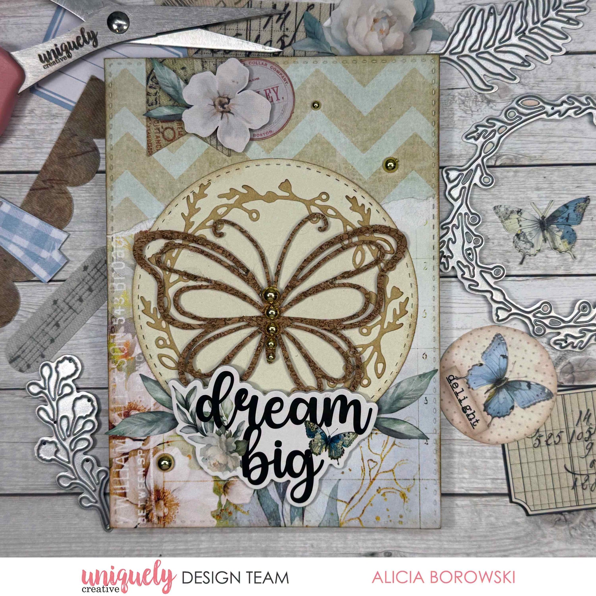 Handmade cardmaking sample using the Uniquely Creative Delicate Butterfly Die, featuring a glittered butterfly die-cut on a cream circle panel with vintage botanical patterned paper and a "dream big" sentiment