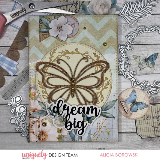 Handmade cardmaking sample using the Uniquely Creative Delicate Butterfly Die, featuring a glittered butterfly die-cut on a cream circle panel with vintage botanical patterned paper and a "dream big" sentiment