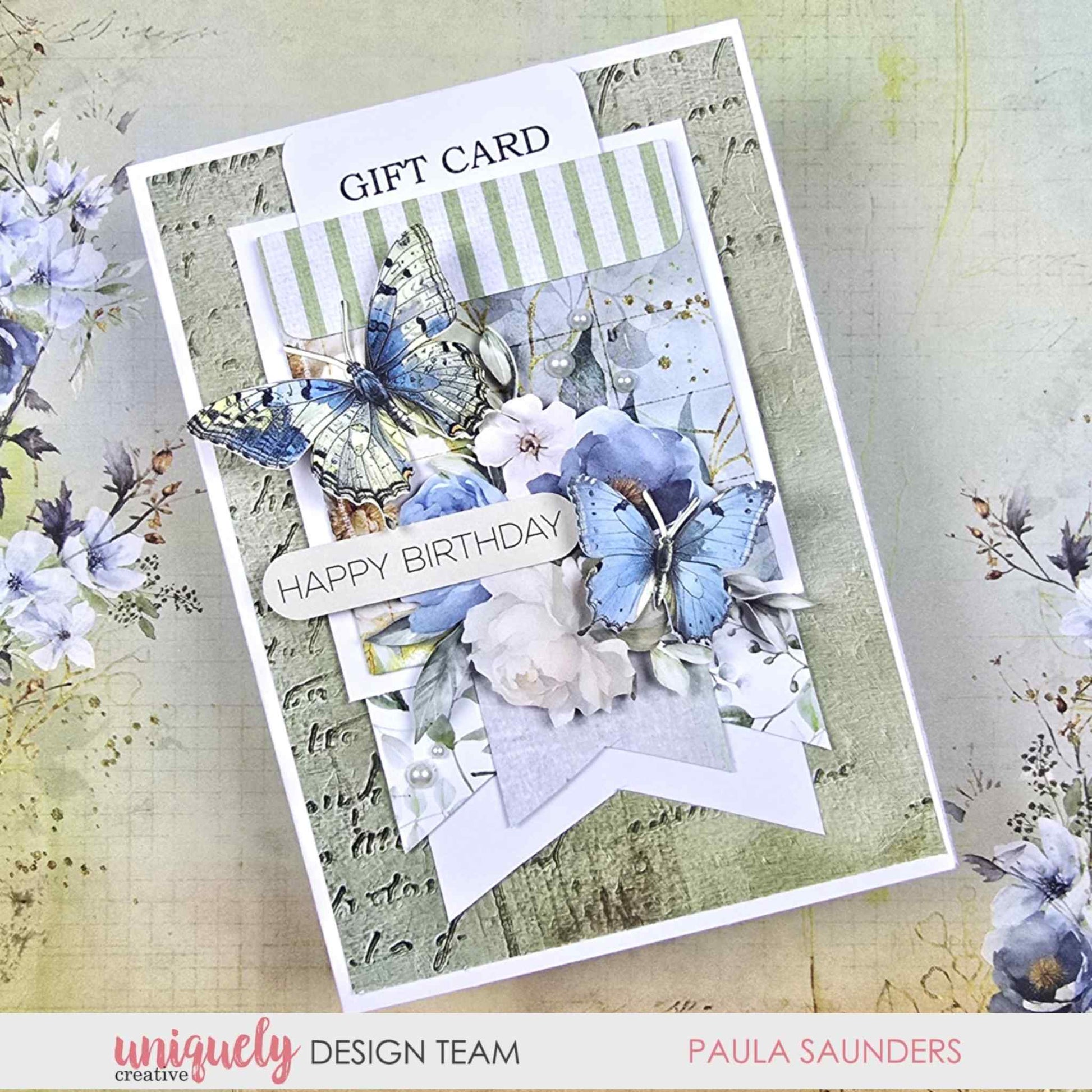 Handmade Happy Birthday gift card holder featuring blue butterfly die-cuts, white peony and blue floral embellishments layered over sage green striped and script patterned papers, made with Uniquely Creative Delighted Curiosities
