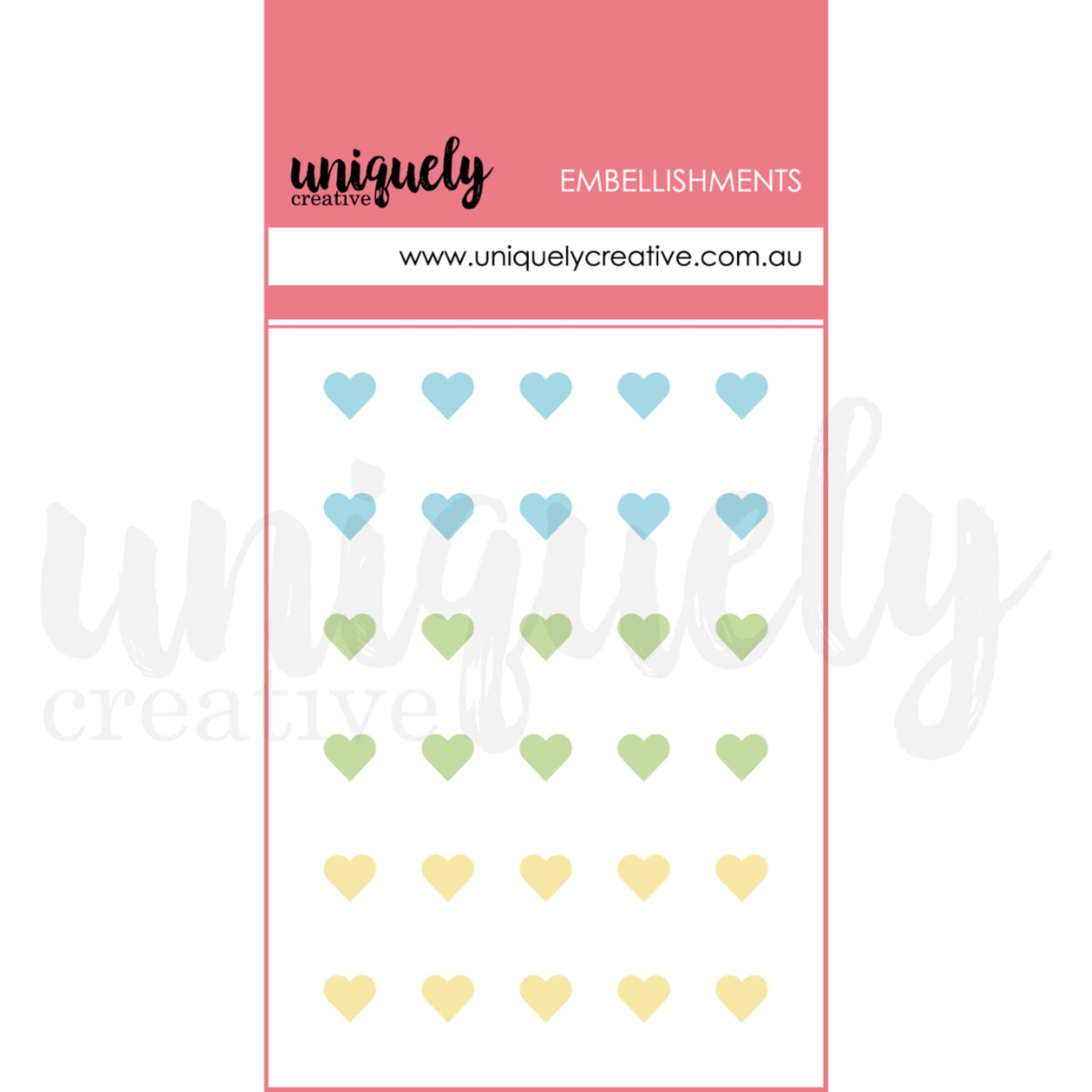 Uniquely Creative Dew Drop Heart Stickers Luminous showing 30 small pearlescent shimmer heart stickers in pastel blue, green, and yellow arranged on pink backing card