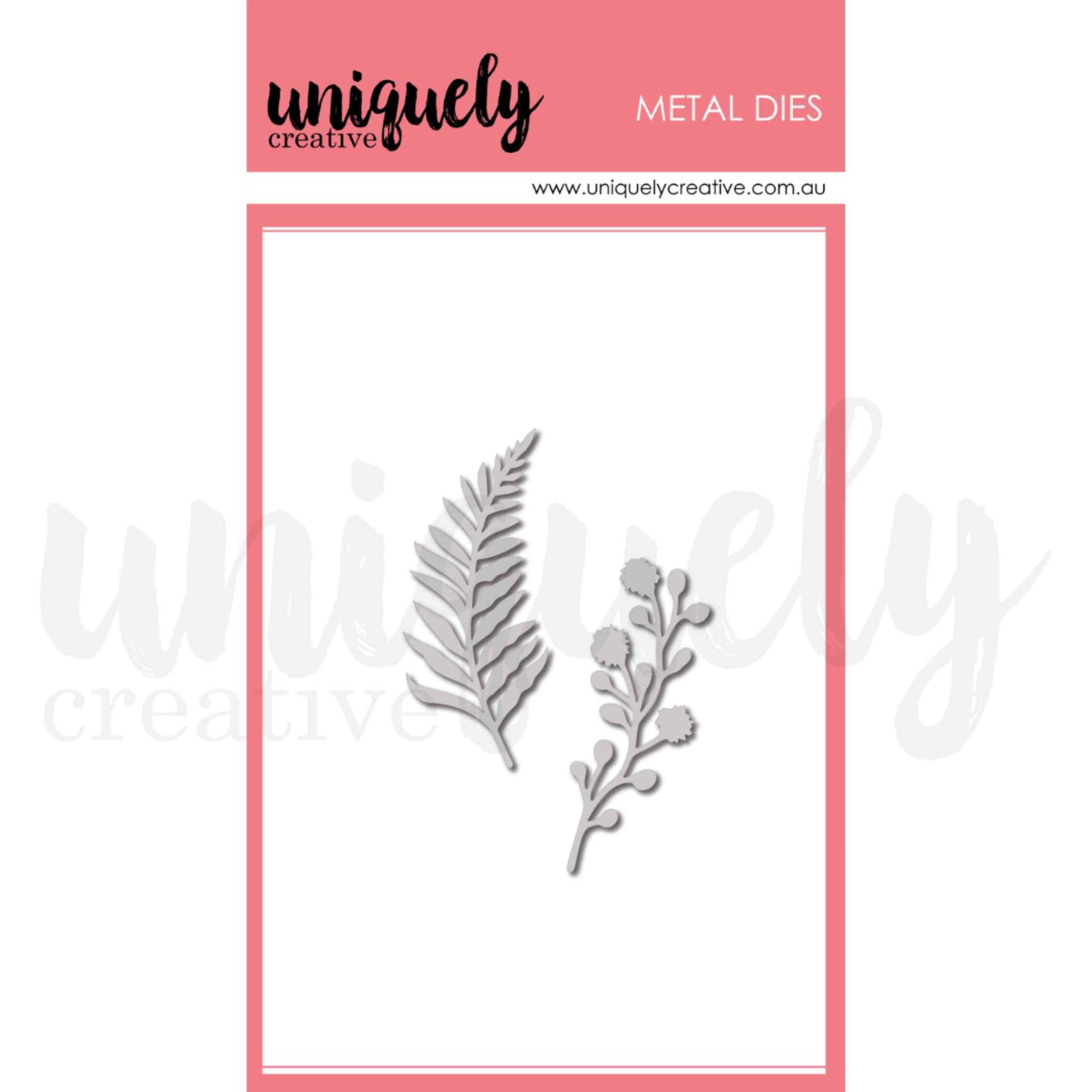 Uniquely Creative Filler Foliage Die set showing two metal cutting dies — a feathery fern frond (approximately 1¼" × 2½") and a delicate berry and flower stem (approximately 1" × 2¼")
