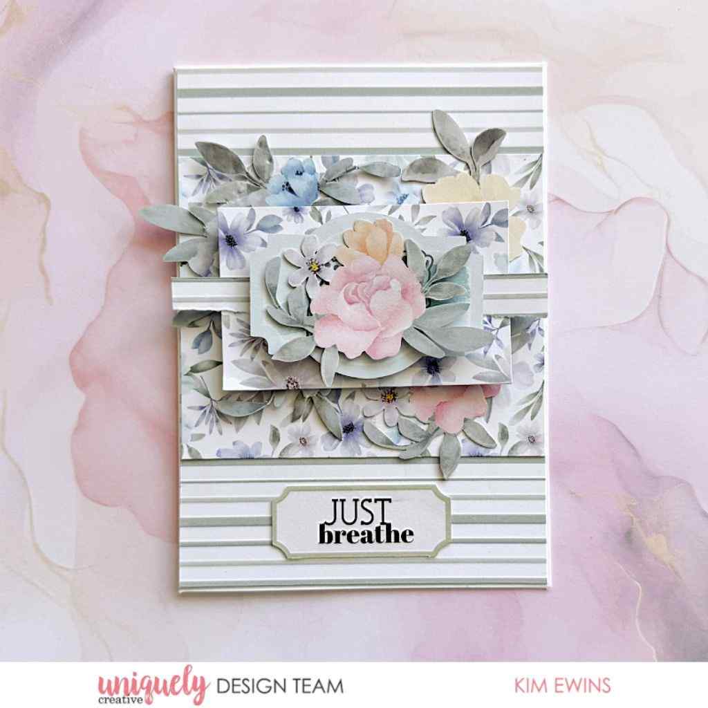 Handmade card sample made with Heart & Soul papers, featuring floral layers, striped paper, a large pink flower and a “Just Breathe” label.